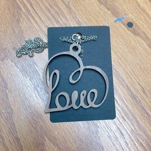 Brand new necklace it is a laser wood that is cut in the shape of a heart.